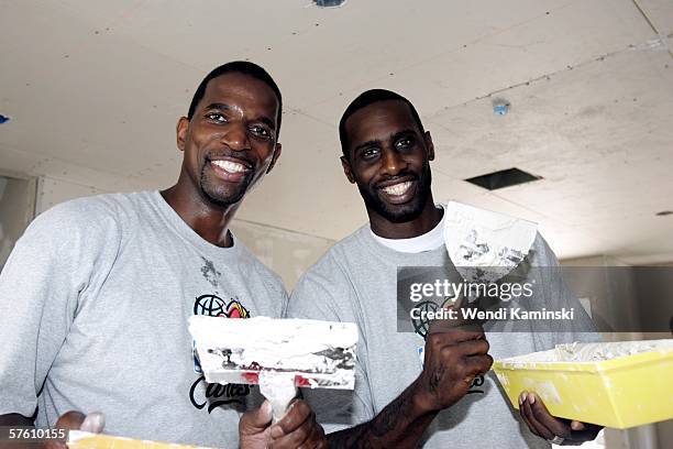 Former Los Angeles Lakers player AC Green and Tim Thomas of the Phoenix Suns work on Habitat Humanity's housing project for Maritza Jacobo's new home...