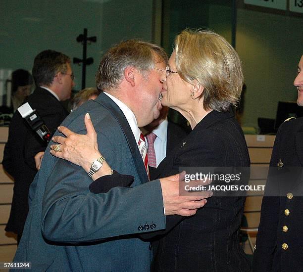 French Minister of Defence, Michele Alliot-Marie, ,and Belgian Minister of Defence Andre Flahaut, left), embrace prior to the start of the Defence...