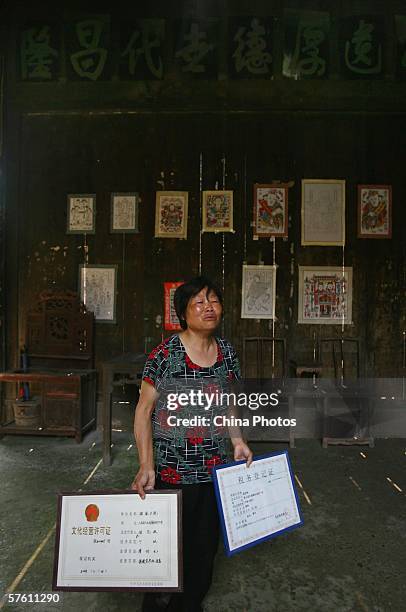 The housemistress of the Wen's Yard, the largest and most well-preserved ancient building in the old town, displays the operator license as a...