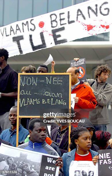 Banner reading "Vlaams Belang kills" is pictured while some 800 citizens of foreign origin and peace activists demonstrate, 14 May 2006, in front of...