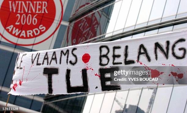 Banner reading "Vlaams Belang kills" is pictured while some 800 citizens of foreign origin and peace activists demonstrate, 14 May 2006, in front of...