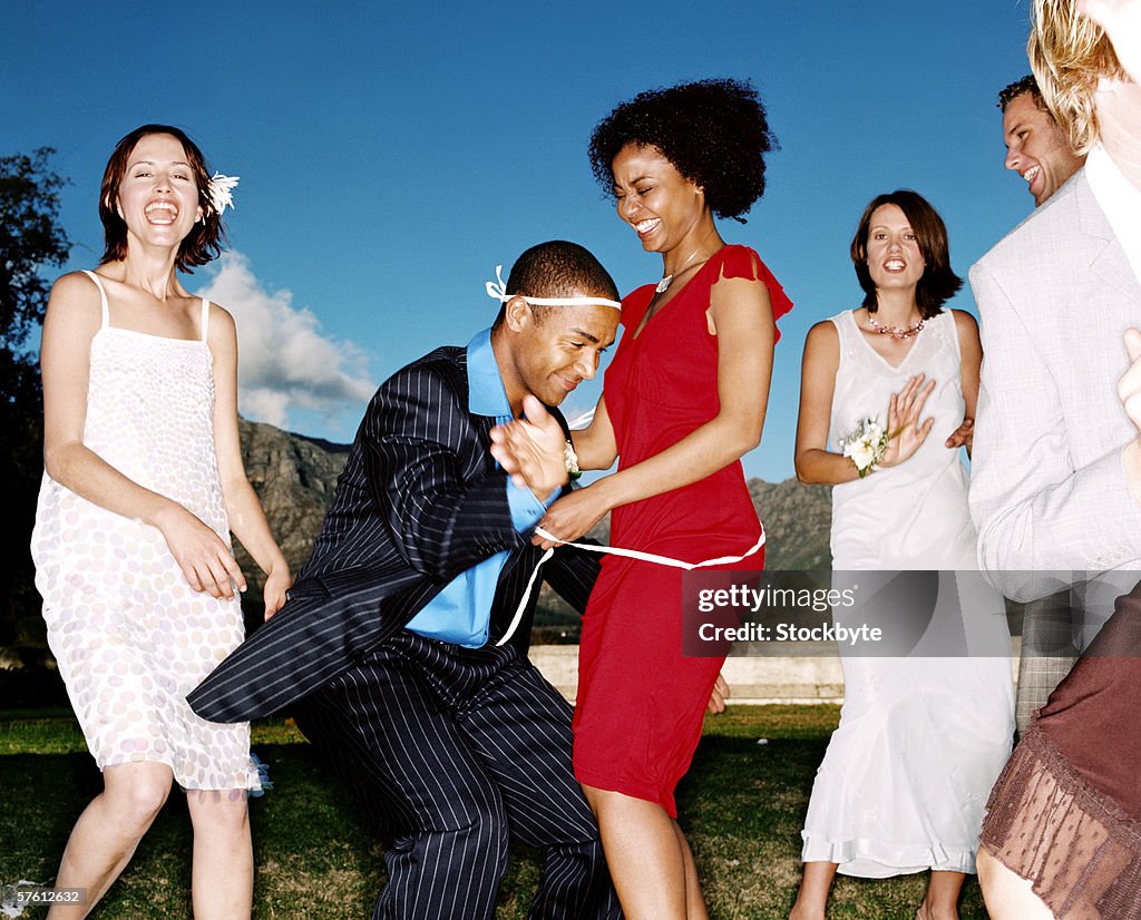 Group of young men and women dancing at a party