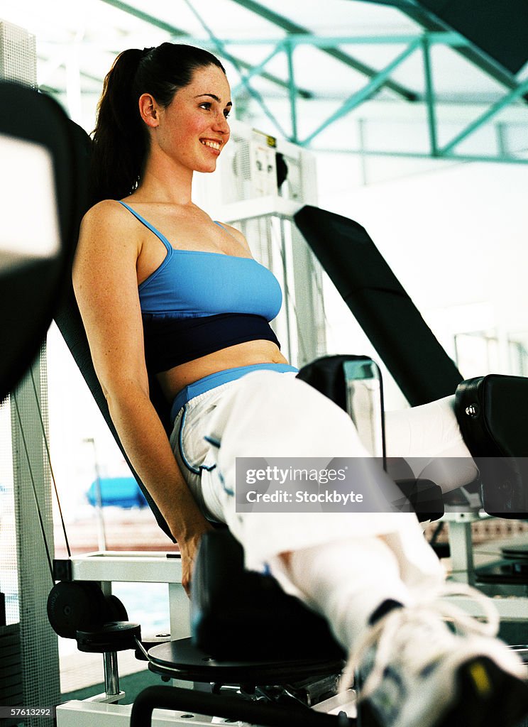 Close-up of a young woman working out at a gymnasium