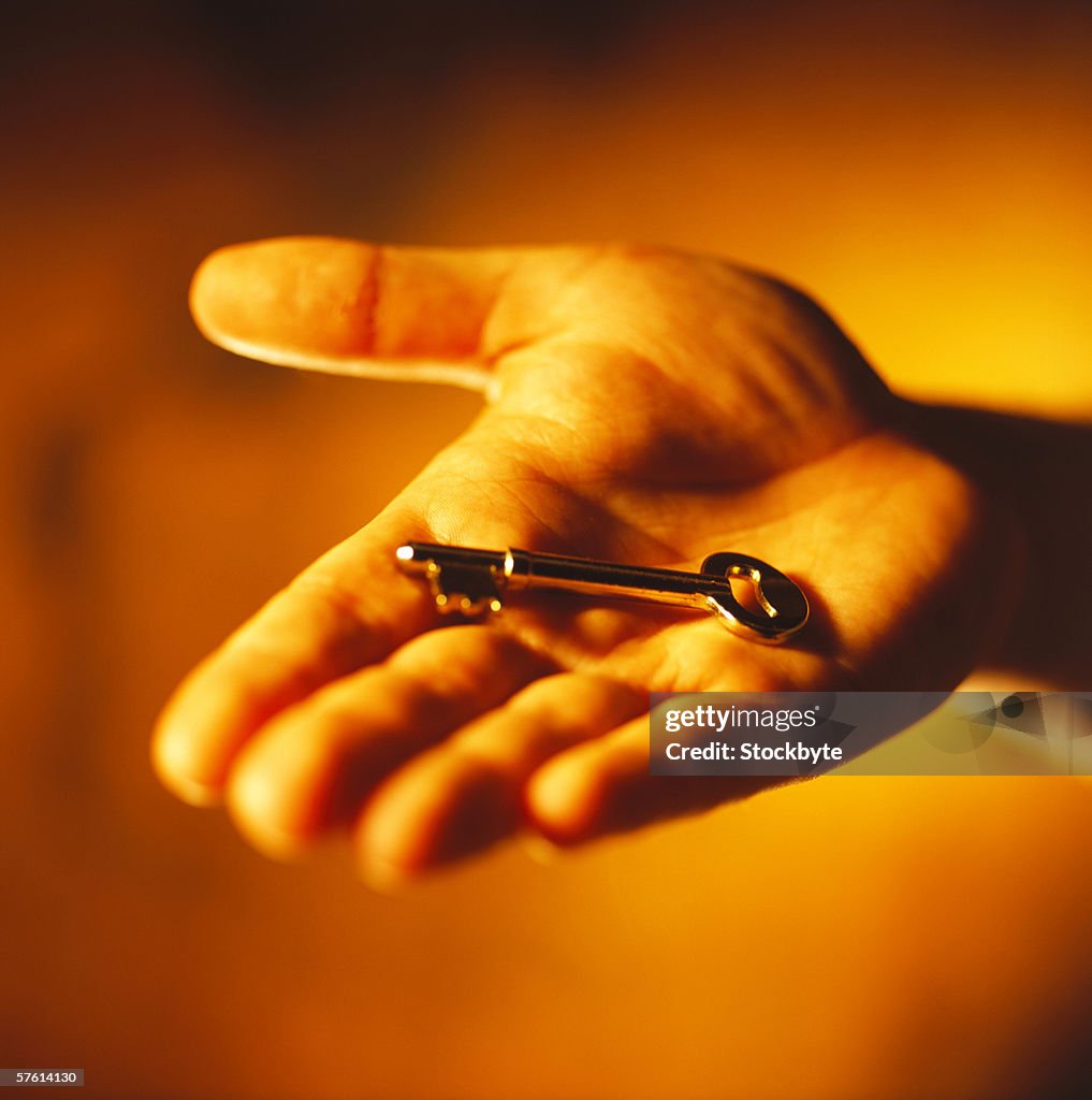 Close-up of a key in person's hand (toned)