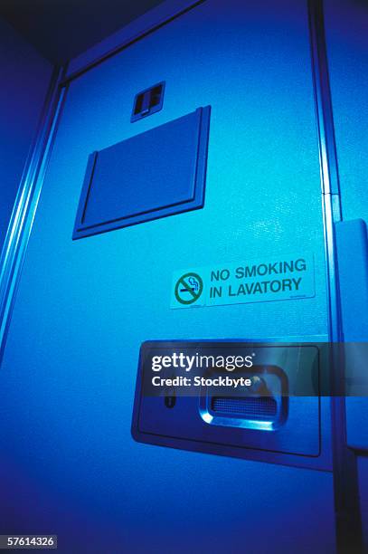 close-up of the door of an airplane toilet (toned) - aircraft lavatory stock pictures, royalty-free photos & images