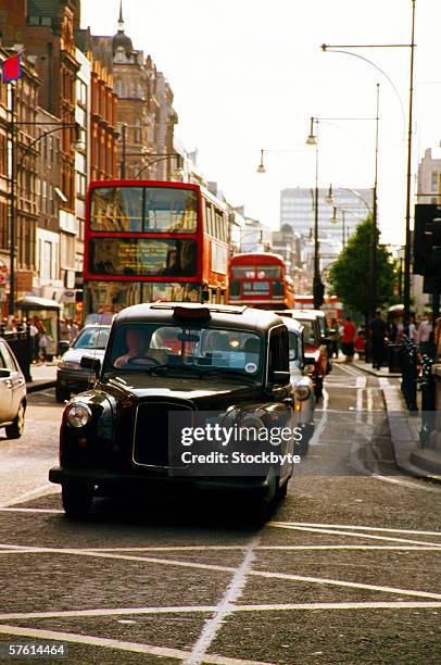 traffic on the streets of london - london taxi ストックフォトと画像