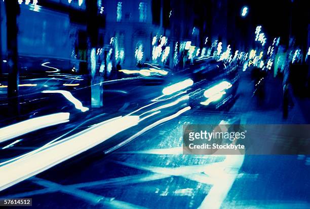 tungsten toned time lapse shot of traffic on a street in the night - traffic time lapse stock pictures, royalty-free photos & images