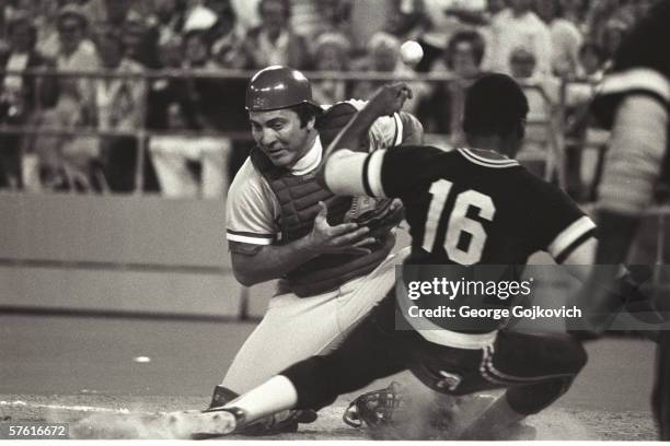 Catcher Johnny Bench of the Cincinnati Reds can't hold on to the ball as outfielder Al Oliver of the Pittsburgh Pirates slides home at Three Rivers...