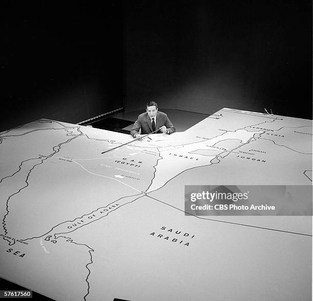 Overhead view of American television journalist Mike Wallace as he reports on the progress of what came to be called the 'Six Day War' from behind a...