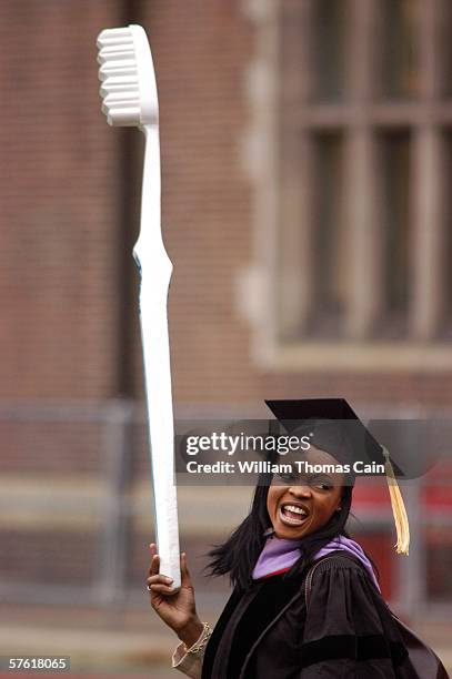 Student from Penn's school of dentistry holds an oversize tooth brush while marching in the procession at the 250th Commencement of the University of...