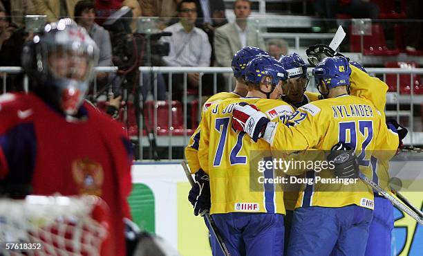 Jorgen Jonsson celebrates with teammates after scoring his side's third goal, whilst Maxim Sokolov the Russian Goaltender looks on during the second...