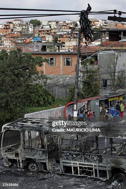 Destroyed bus burned by gang members during the night blocks a street, in Campo Limpo neighborhood,south area of Sao Paulo, Brazil, 15 May 2006....