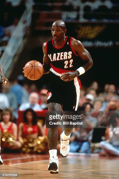 Clyde Drexler#22 of the Portland Trail Blazers moves the ball up court during a game against the Houston Rockets at The Summit in 1994 in Houston,...