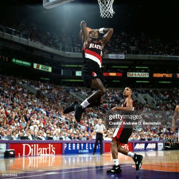 Clyde Drexler#22 of the Portland Trail Blazers dunks against the Phoenix Suns during a game at America West Arena on November 19, 1994 in Phoenix,...