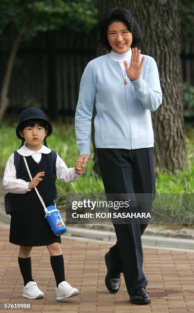 Crown Princess Masako and her daughter Princess Aiko wave to photographers as they arrive at the Shinjuku Gyoen Park for the princess' kindergarten...