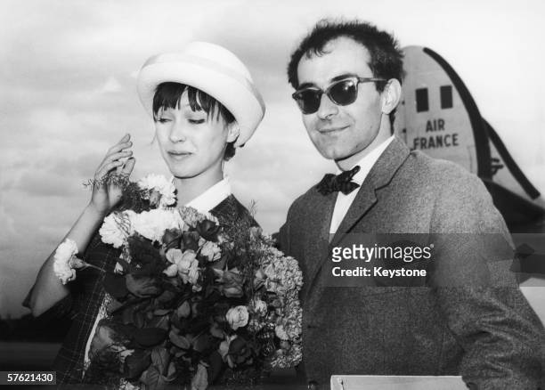 French film director Jean-Luc Godard arriving at Berlin airport with his wife, Danish actress Anna Karina, 28th June 1961. The couple are in town for...