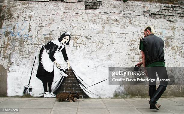 Graffitti art by the 'guerilla' artist Banksy is seen on May 16, 2006 in Chalk Farm, London. The striking large scale spray-painted image entitled...