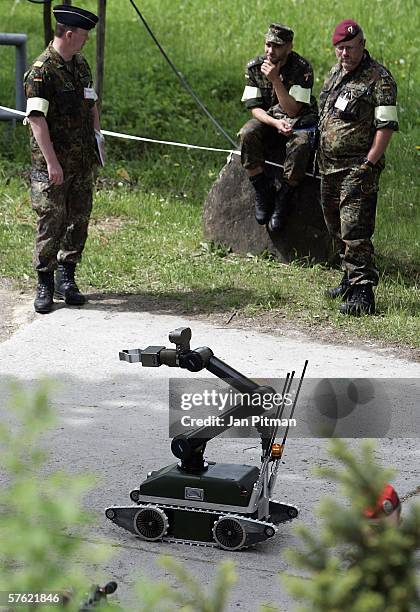 Soldiers watch a land-robot in action on May 16, 2006 at the German army base in Hammelburg, Germany. 21 exhibitors from 8 european countries show...