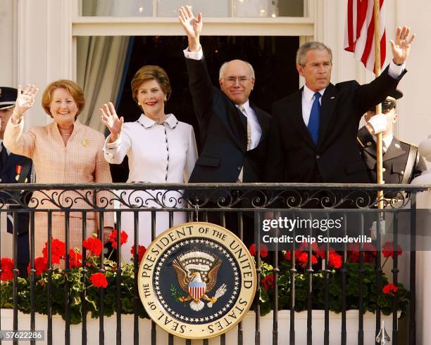 President George W. Bush waves with Australian Prime Minister, John Howard , first lady Laura Bush and Janette Howard , as they stand on the Truman...