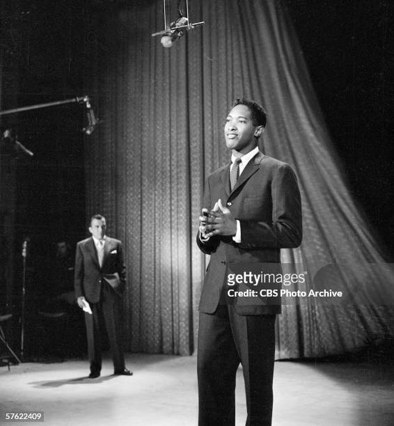 American rhythm and blues, soul, and pop singer Sam Cooke performs on the CBS variety show 'Toast of the Town' as series empresario Ed Sullivan ,...