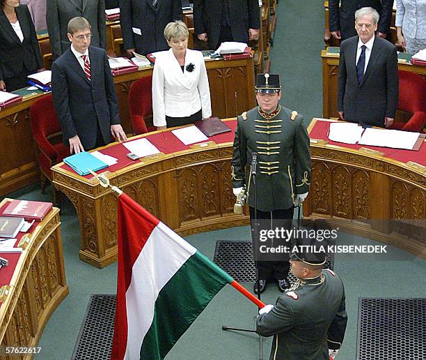 Accompanied by chief of honour guard, the national tricolor arrives into the gala hall of the parliamaent building in front of the Hungarian leaders,...