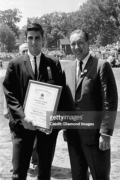 Pitcher Roland "Rollie" Fingers, from Upland, California, is presented with the American League Player of the Year award for 1964 by former pitcher...
