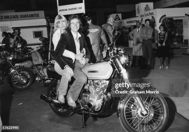 British motorcycling champion Barry Sheene and his girlfriend, glamour model Stephanie McLean, astride his new Suzuki GS750 four-stroke at the Earl's...