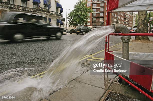 Burst pipe spews water onto a street near Lancaster Gate on May 16, 2006 in London, England. One of the driest periods in 70 years has caused...