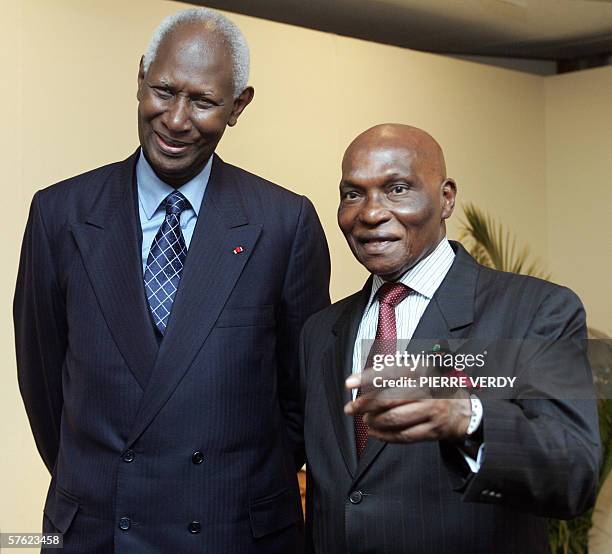 Senegalese President Abdoulaye Wade speaks with Abdou Diouf, secretary general of La Francophonie and also former President of Senegal, before...