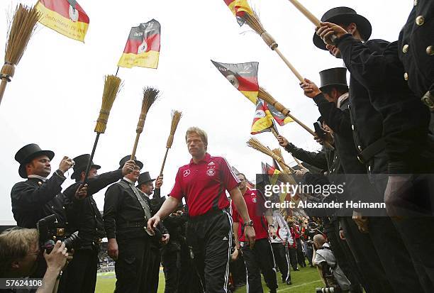 Oliver Kahn of Germany walks through a line of chimney sweeps after the match between FSV Luckenwalde and the German National Team at the Carl-Benz...