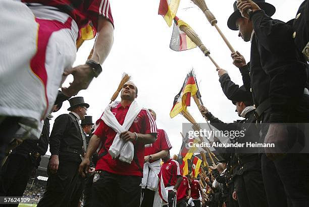 David Odonkor of Germany walks through a line of chimney sweeps after the match between FSV Luckenwalde and the German National Team at the Carl-Benz...