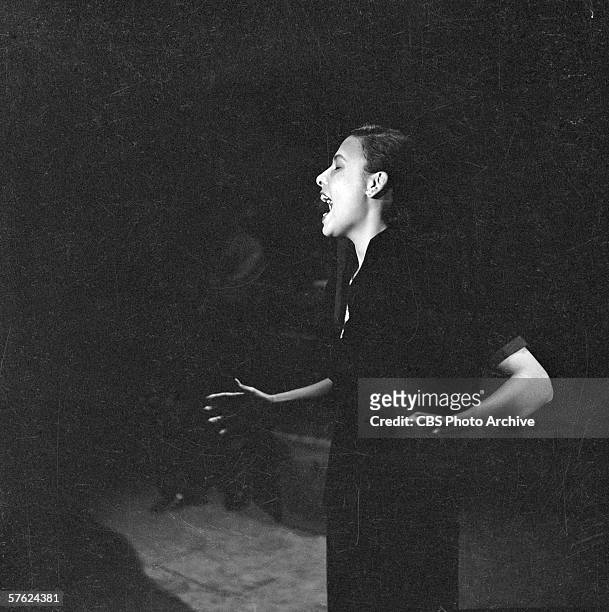 American singer and actress Lena Horne performs in a tight spotlight on Ed Sullivan's CBS variety show 'Toast of the Town,' New York September 9,...