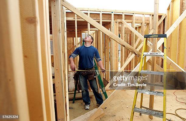 Tomasz Zarebczan works on a single-family home under construction May 16, 2006 in Mount Prospect, Illinois. Housing starts reportedly were down last...