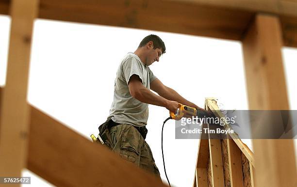 Stanley Mietus works on a single-family home under construction May 16, 2006 in Mount Prospect, Illinois. Housing starts reportedly were down last...