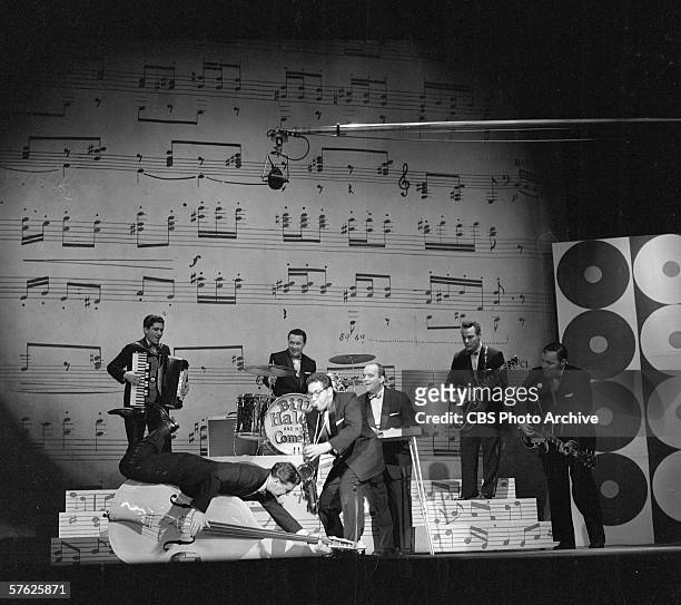 American rock and roll band Bill Haley and his Comets perform raucously on Ed Sullivan's CBS variety show 'Toast of the Town,' April 28, 1957. The...