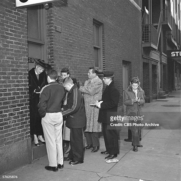 American comedian and actress Lucille Ball and her husband, Cuban-born American bandleader and actor Desi Arnaz , sign autographs for fans in an...