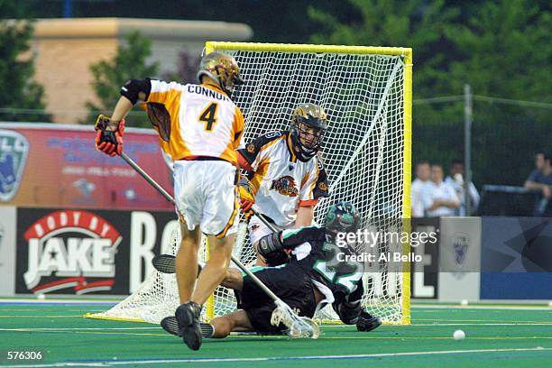 Casey Powell of the Long Island Lizards fights for the ball against Casey Conner and Brian Doughrety of the Rochester Rattlers during their Major...