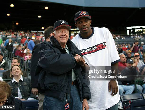 Former United States President Jimmy Carter poses with Atlanta Hawks guard Joe Johnson before the Atlanta Braves game against the Florida Marlins on...