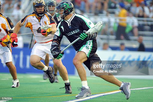 Gary Gait of the Long Island Lizards runs with the ball against Regy Thorpe of the Rochester Rattlers during their Major League Lacrosse home opener...