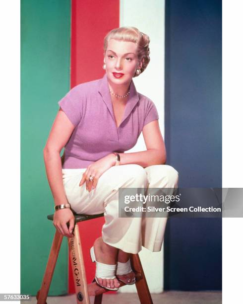 American actress Lana Turner perches on an MGM stool, circa 1950.