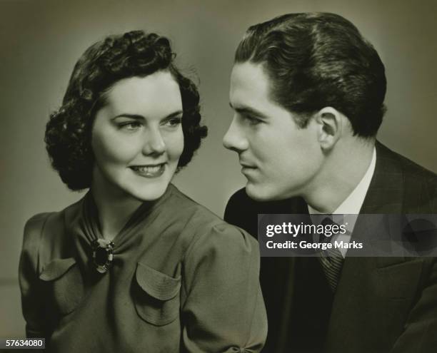 couple looking in eyes, posing in studio, (b&w), portrait - 1940's stock pictures, royalty-free photos & images