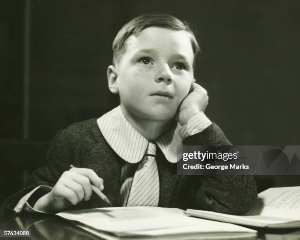 boy (6-7) doing homework, (b&w), portrait - dull pencil stock pictures, royalty-free photos & images
