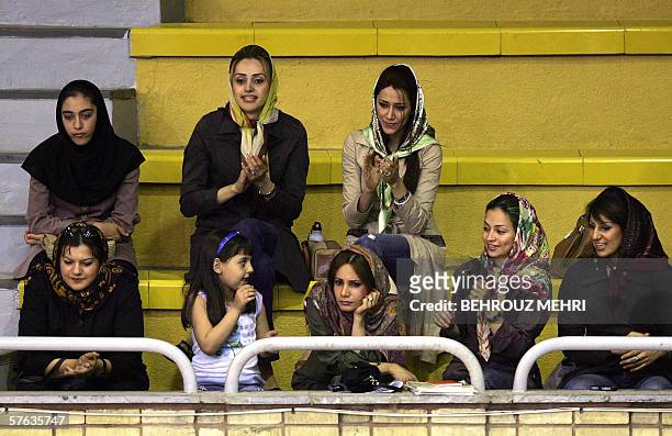 Female supporters of Iran's Saba Battery basketball team watch a game in Tehran 17 May 2006. Saba battery was playing lebanon's La Sagesse in the...