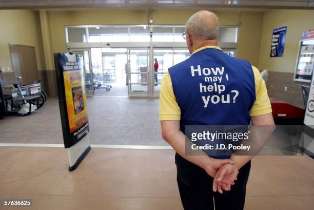 Wal-Mart greeter waits to welcome new customers to the new 2,000 square foot Wal-Mart Supercenter store May 17, 2006 in Bowling Green, Ohio. The new...