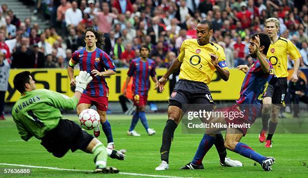 Victor Valdes the Barcelona goalkeeper saves from Thierry Henry of Arsenal during the UEFA Champions League Final between Arsenal and Barcelona at...