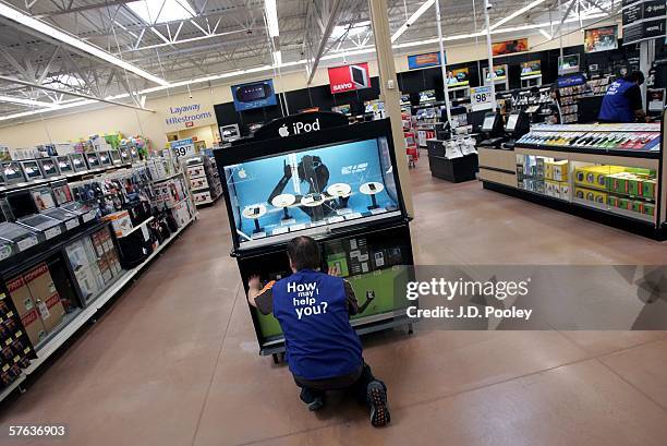 Wal-Mart employee reaches for an Ipod at the new 2,000 square foot Wal-Mart Supercenter store May 17, 2006 in Bowling Green, Ohio. The new store, one...