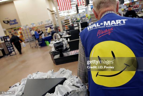 Clayton Fackler works at the checkout at the new 2,000 square foot Wal-Mart Supercenter store May 17, 2006 in Bowling Green, Ohio. The new store, one...