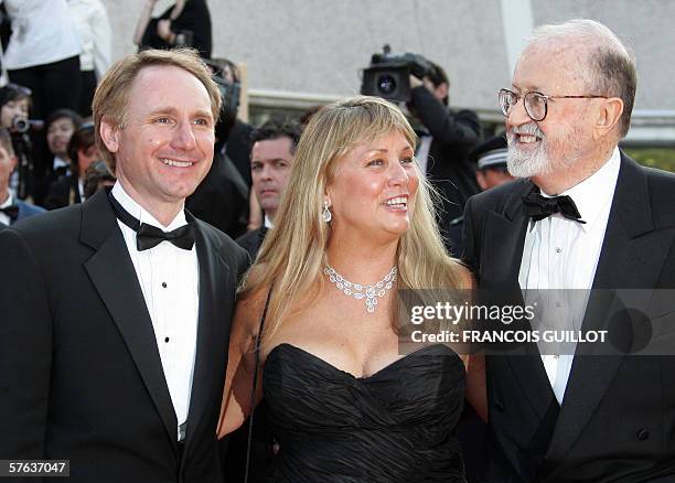 Author Dan Brown and his wife Blythe pose with US producer John Calley as they arrive to attend the opening ceremony of the 59th edition of the...