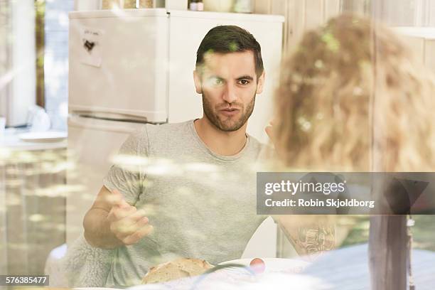 young man talking behind window - vig denmark stock pictures, royalty-free photos & images