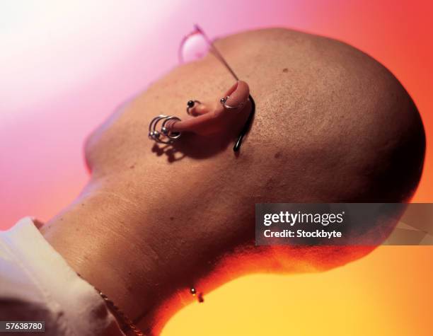 side profile of a bald man with piercing on his ear and nape of neck - nape of neck stock pictures, royalty-free photos & images